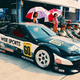 a toyota cavalier race car in the pit box at a race track in the late 1990s